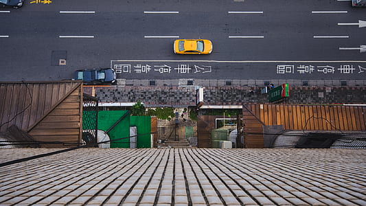 aerial photography of yellow car on concrete road thumbnail