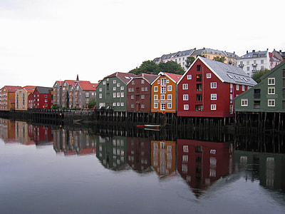 assorted-color houses near body of water thumbnail