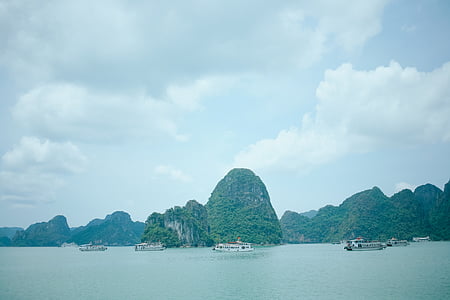 island under cloudy sky thumbnail