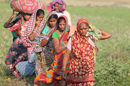 group of women walking on grass field thumbnail