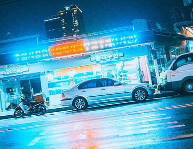 silver sedan on road thumbnail