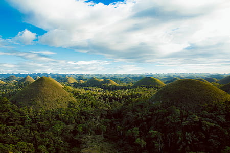 Scenic View of Hills Surrounded By Trees thumbnail
