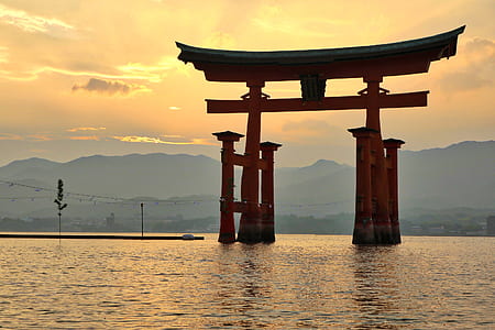 red arch surrounded by body of water thumbnail