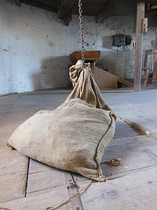 brown sack on chain near wall thumbnail