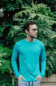 man standing near green plants thumbnail