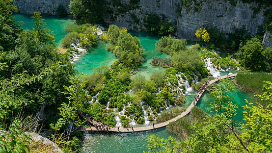 aerial photography of bridge crossing the river at rock formation during daytime thumbnail