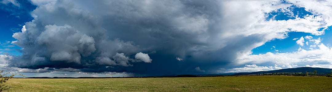 landscape photo of green grass under white clouds at daytime thumbnail
