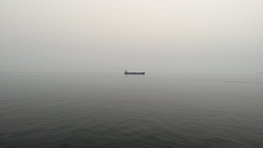 aerial photography of boat sailing on large body of water thumbnail