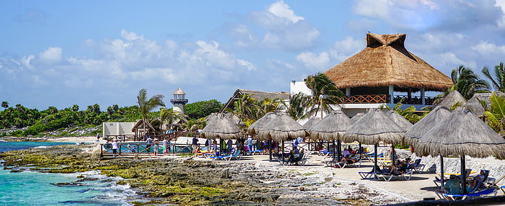 brown hut at beach during daytime thumbnail