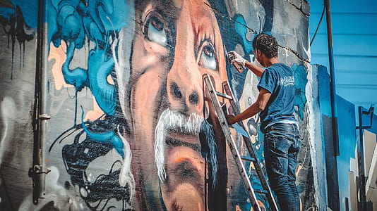 man painting on wall thumbnail
