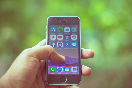 person holding turned-on space gray iPhone 5s thumbnail
