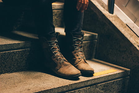 person wearing black pants and brown boots thumbnail