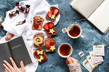 strawberry jam sandwich beside cup of tea thumbnail