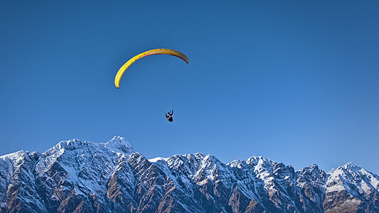 person parachuting above the mountains thumbnail