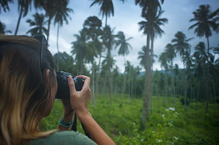 Woman Holding Dslr Camera Taking Photo thumbnail