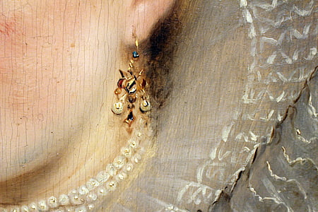 gold-colored drop earring hanged on woman painting thumbnail