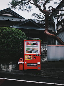red beverage vending machine on side walk thumbnail