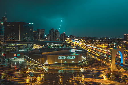 Bird's Eye View of Grey Building Near Road and Thunder Lighting Strike in Background thumbnail