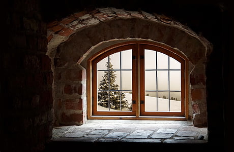 shallow photography of brown wooden glass-panel door with concrete bricked frame thumbnail