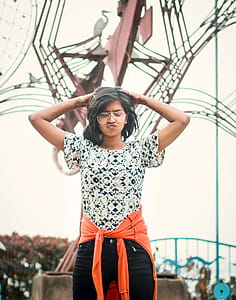 Women With Pouting Mouth Standing Near Brown Statue thumbnail
