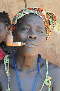 woman wearing turban smoking in smoking pipe thumbnail