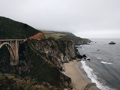 aerial photography of mountain and beach thumbnail