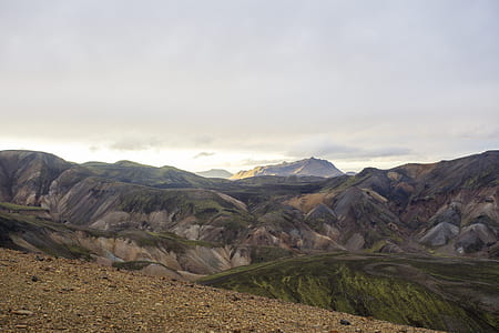 green hill under white clouds thumbnail