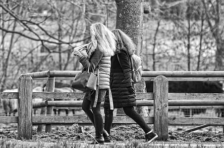 grayscale photography of two women walking side by side at ranch thumbnail