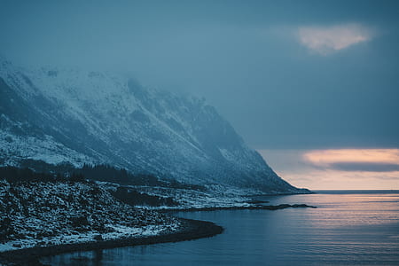 black and white glacier mountain near body of water thumbnail