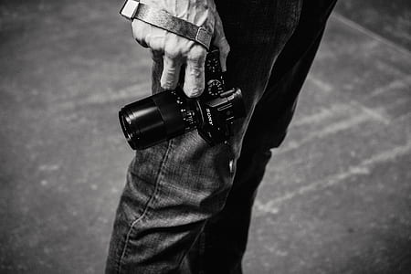 man holding DSLR camera thumbnail