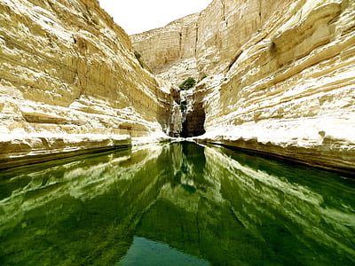 river between beige rock formation during daytime thumbnail