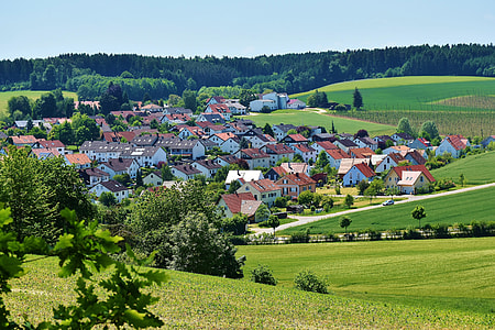a lot of white houses near grass field during daytime thumbnail