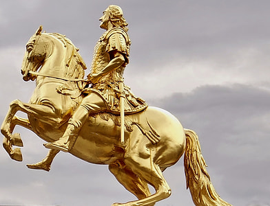 gold-coloured statue of a man wearing armor riding a horse thumbnail