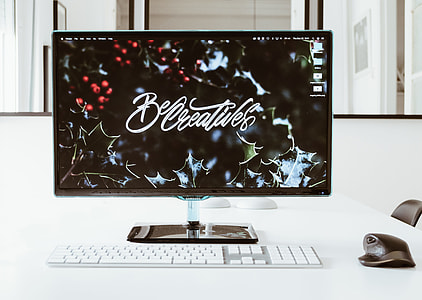 black flat screen monitor and white magic keyboard thumbnail