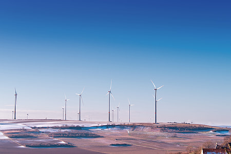 windmills near body of water thumbnail