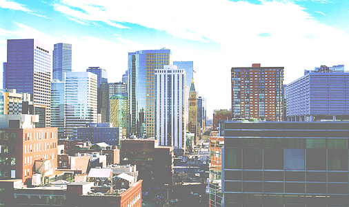 assorted-colored buildings under white clouds and blue sky thumbnail