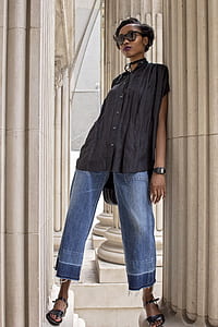 woman leaning on white wall thumbnail