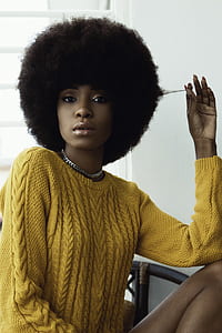 selective focus photo of woman wearing yellow sweater thumbnail