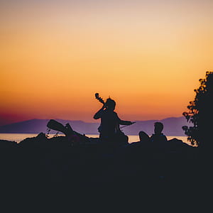 silhouette of woman playing cello thumbnail