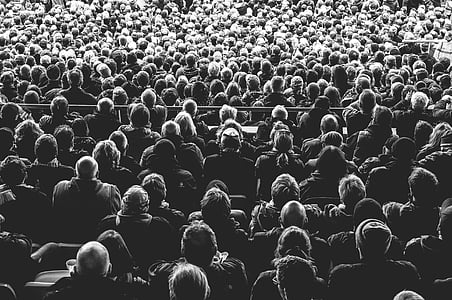 grayscale photography of group of people sitting on chair thumbnail