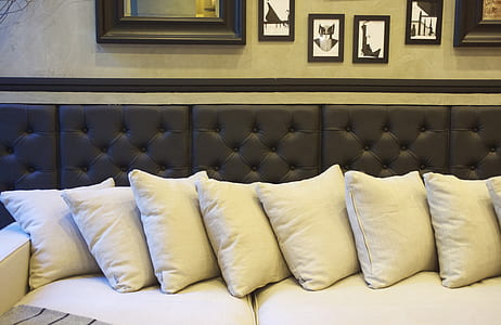 white throw pillows on tufted black and white sofa thumbnail