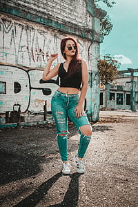 woman standing near concrete building during daytime thumbnail