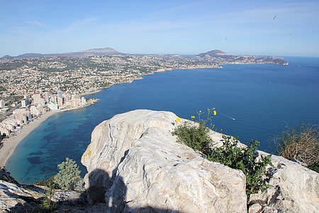 top view of mountain cliff near body of water thumbnail