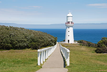 white concrete light tower facing horizon thumbnail