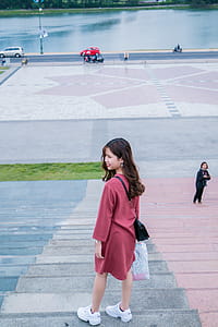 Woman Wearing Red Clothes and Pair of White Running Shoes thumbnail