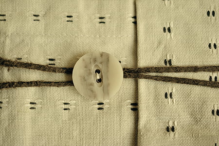 beige clothes button thumbnail