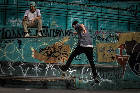 Man Wearing Geay Shirt Playing Skateboard thumbnail