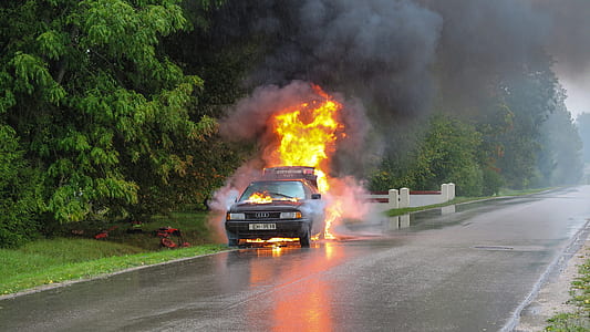 black vehicle on fire near the trees thumbnail