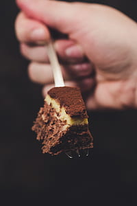 person holding fork with sliced of cake thumbnail