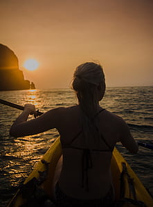 woman kayaking on sea thumbnail